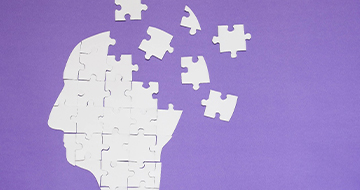 Puzzle pieces forming human head