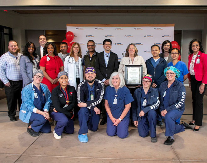 Group of healthcare staff with recognition award