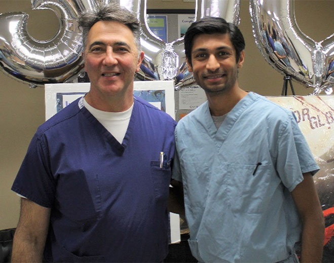 Two clinicians standing with balloons indoors