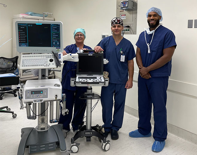 Medical team standing beside imaging equipment
