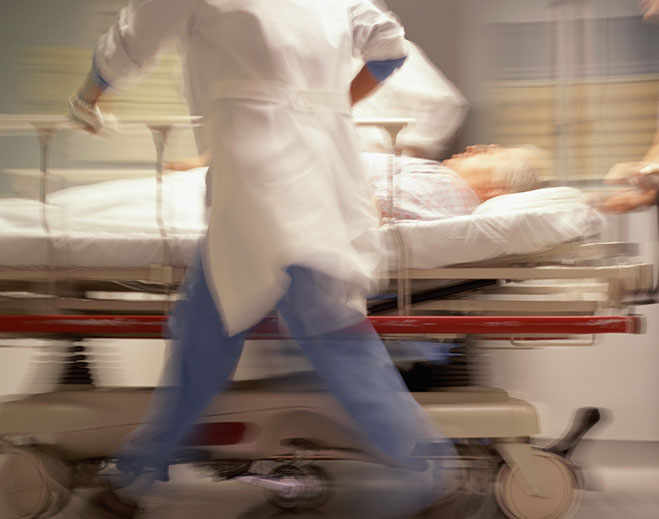Hospital staff rushing patient on stretcher