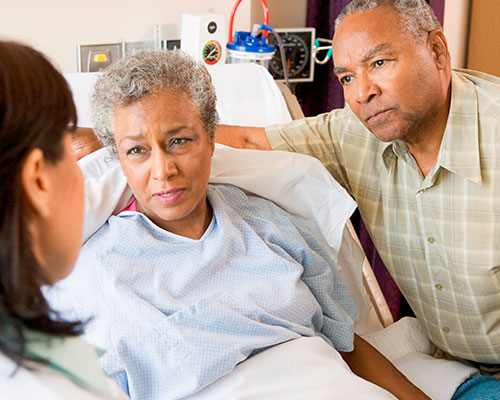 Patient speaking with clinician in hospital room