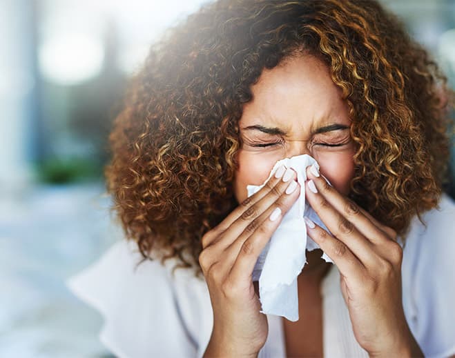 Person holding tissue near nose