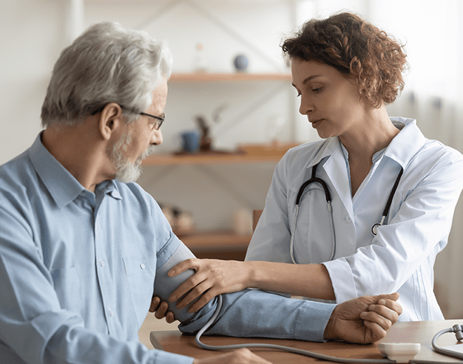 Clinician checking patient blood pressure