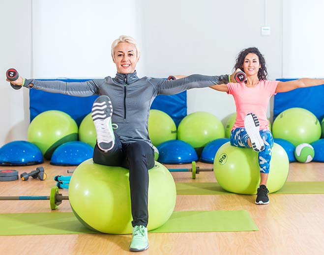 Two people exercising on stability balls
