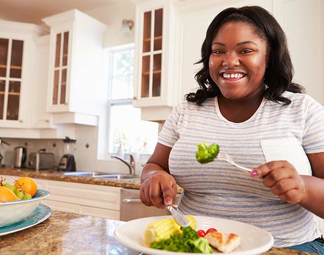 Woman eating healthy meal at home