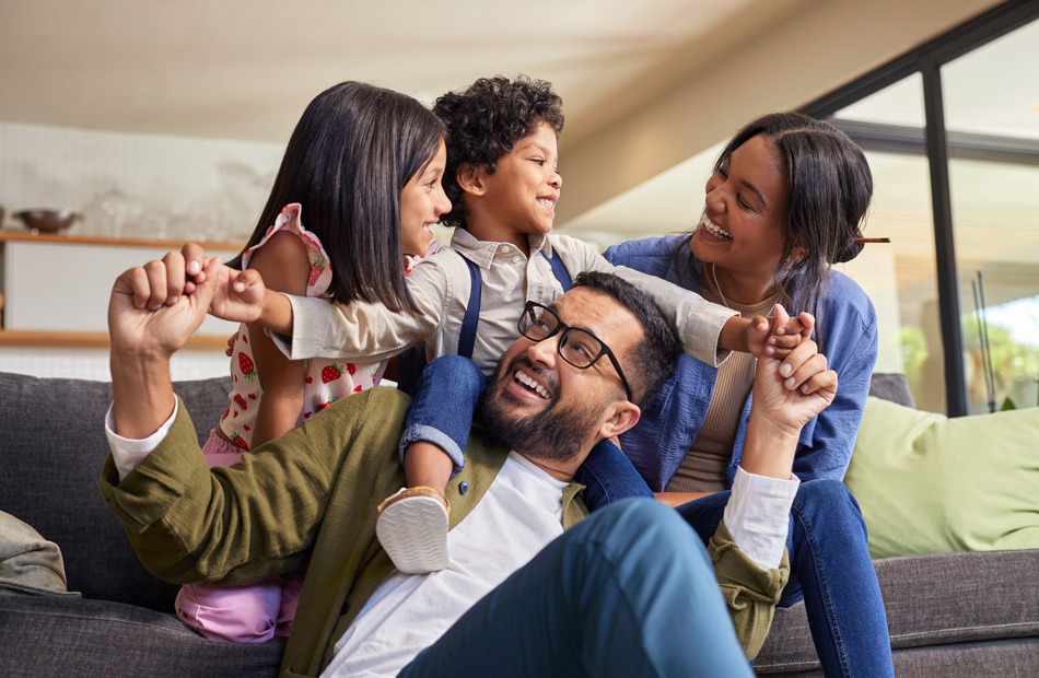 Family sitting together on living room couch